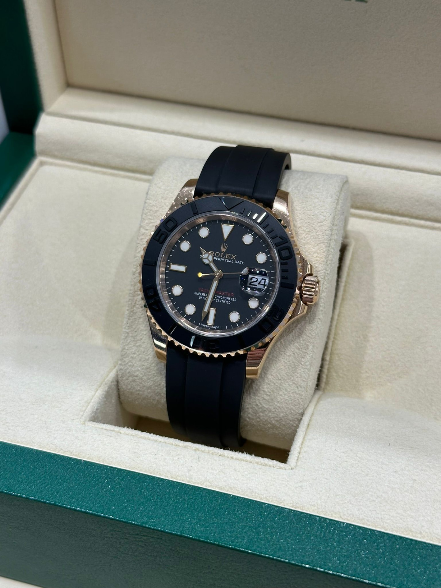 A wristwatch beside a watchmaker's loupe